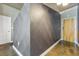 Hallway showing a gray textured wall with geometric design and doorways at 923 Peachtree Ne St # 1625, Atlanta, GA 30309