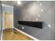 Hallway featuring a modern gray textured wall with decorative figurines and a floating shelf at 923 Peachtree Ne St # 1625, Atlanta, GA 30309