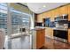 Modern kitchen with a stainless-steel appliances, island, and access to a balcony with city views at 923 Peachtree Ne St # 1625, Atlanta, GA 30309