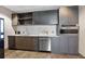 Well-equipped kitchenette with gray cabinets, stainless steel appliances, and a white subway tile backsplash at 923 Peachtree Ne St # 1625, Atlanta, GA 30309