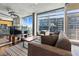 Contemporary living space with expansive windows, stylish furnishings, and an open layout to the kitchen at 923 Peachtree Ne St # 1625, Atlanta, GA 30309
