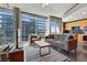 Modern living room featuring large windows and a comfortable seating area with an adjacent kitchen at 923 Peachtree Ne St # 1625, Atlanta, GA 30309