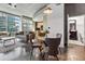 Bright living room with city views and an adjacent dining area next to the entry to the bathroom at 923 Peachtree Ne St # 1625, Atlanta, GA 30309