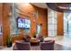 Elegant lobby with wooden walls, four armchairs, a media screen, plants, and contemporary design at 923 Peachtree Ne St # 1625, Atlanta, GA 30309