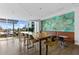 Bright meeting room with large windows, an accent wall, and a large wooden table with barstool style chairs at 923 Peachtree Ne St # 1625, Atlanta, GA 30309