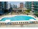 Resort-style condo complex boasts a large pool with sundeck and lounge area, set against a backdrop of the city at 923 Peachtree Ne St # 1625, Atlanta, GA 30309
