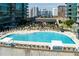 Luxury condominium complex featuring a large outdoor pool surrounded by comfortable lounge chairs and city views at 923 Peachtree Ne St # 1625, Atlanta, GA 30309