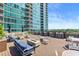 Relaxing rooftop deck with outdoor bar area, furniture, and relaxing fire pits at 923 Peachtree Ne St # 1625, Atlanta, GA 30309