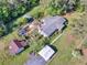 Aerial view of the property featuring a large backyard, outbuildings, and mature trees at 1025 Rocky Plains Rd, Covington, GA 30016