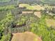 Aerial view of property showing mature trees, open fields, and a small pond at 1025 Rocky Plains Rd, Covington, GA 30016