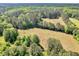 Overhead view of a large lot featuring green trees, open fields, and peaceful surrounding at 1025 Rocky Plains Rd, Covington, GA 30016