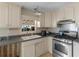 Functional kitchen features wood cabinets, laminate countertops, and a gas range at 1025 Rocky Plains Rd, Covington, GA 30016