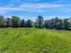 Sprawling grassy field under a clear blue sky, perfect for outdoor activities and enjoying nature's beauty at 1025 Rocky Plains Rd, Covington, GA 30016