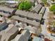 A high aerial view of a complex of suburban townhomes with shingled roofs at 10686 Austen Bnd, Alpharetta, GA 30022