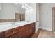 Bathroom featuring a double vanity with white countertop and dark cabinets at 10686 Austen Bnd, Alpharetta, GA 30022