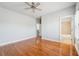 Bedroom with wood floors and shutters, door to bathroom at 10686 Austen Bnd, Alpharetta, GA 30022