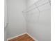 Walk-in closet with hardwood floor, wire shelving, and base molding at 10686 Austen Bnd, Alpharetta, GA 30022