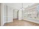 Bright dining room with hardwood floors, white trim and light fixture at 10686 Austen Bnd, Alpharetta, GA 30022