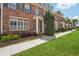 Beautiful townhouses with manicured lawns and sidewalks on a sunny day at 10686 Austen Bnd, Alpharetta, GA 30022