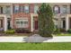 Attractive brick townhouse featuring a well-manicured lawn and landscaped garden at 10686 Austen Bnd, Alpharetta, GA 30022