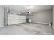 Attached garage with roll up door, concrete floor, and grey walls at 10686 Austen Bnd, Alpharetta, GA 30022