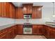 Traditional kitchen with wood cabinets, stainless steel appliances, and granite countertops at 10686 Austen Bnd, Alpharetta, GA 30022