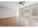 Expansive living room featuring hardwood floors, abundant natural light, and neutral tones at 10686 Austen Bnd, Alpharetta, GA 30022