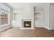 Bright living room with built-in shelves and a cozy fireplace at 10686 Austen Bnd, Alpharetta, GA 30022