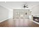 Bright living room with fireplace, ceiling fan, and plenty of natural light at 10686 Austen Bnd, Alpharetta, GA 30022
