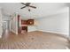 Open-concept living space with hardwood floors connecting to the kitchen area at 10686 Austen Bnd, Alpharetta, GA 30022