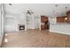 Open-concept living space featuring hardwood floors, fireplace and modern kitchen at 10686 Austen Bnd, Alpharetta, GA 30022