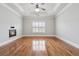 Spacious bedroom featuring elegant tray ceilings, a fireplace, and hardwood floors at 10686 Austen Bnd, Alpharetta, GA 30022