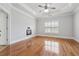 Large bedroom featuring a tray ceiling, fireplace, and hardwood flooring at 10686 Austen Bnd, Alpharetta, GA 30022