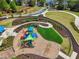 Aerial view of a modern playground with colorful equipment and landscaped walkways in a community park at 10686 Austen Bnd, Alpharetta, GA 30022