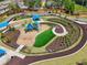 Community playground featuring slides, swings, and covered picnic areas surrounded by lush landscaping and walking paths at 10686 Austen Bnd, Alpharetta, GA 30022
