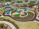 Aerial view of a community park with playground, tennis court, picnic pavilions, walkways, and landscaping at 10686 Austen Bnd, Alpharetta, GA 30022