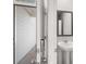 Modern bathroom featuring a pedestal sink and a framed mirror at 8234 Coldstream Dr, Fairburn, GA 30213