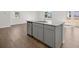 Open kitchen with stainless steel appliances, granite countertops, and hardwood floors at 8234 Coldstream Dr, Fairburn, GA 30213