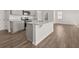 Modern kitchen with granite countertops, stainless steel appliances, and hardwood floors at 8234 Coldstream Dr, Fairburn, GA 30213