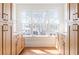 Bathroom featuring dual wooden vanities, white countertops, and three windows with natural light at 1585 S Ponce De Leon Ne Ave # 20, Atlanta, GA 30307