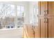Bathroom vanity featuring wooden cabinets, light countertop, and a large window at 1585 S Ponce De Leon Ne Ave # 20, Atlanta, GA 30307