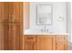 Bathroom vanity with wooden cabinets, white countertop and a mirror at 1585 S Ponce De Leon Ne Ave # 20, Atlanta, GA 30307