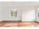 Empty bedroom showcasing hardwood floors and a large window with natural light at 1585 S Ponce De Leon Ne Ave # 20, Atlanta, GA 30307