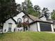 Beautiful home with a well manicured lawn, two car garage, and a combination of brick and painted finishes at 2657 Mcguire Nw Dr, Kennesaw, GA 30144