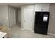 Kitchen area featuring a new refrigerator, matching upper cabinets, and laminate flooring at 2657 Mcguire Nw Dr, Kennesaw, GA 30144
