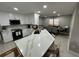 Bright, open kitchen featuring a large island with a marble countertop, modern appliances, and an adjacent dining area at 2657 Mcguire Nw Dr, Kennesaw, GA 30144