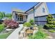 Charming backyard featuring a covered patio, lush landscaping, and a peaceful water feature at 3460 Montebello Pkwy, Cumming, GA 30028