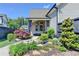 Charming backyard featuring a covered patio, lush landscaping, and a peaceful water feature at 3460 Montebello Pkwy, Cumming, GA 30028