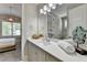 Charming bathroom with a gray vanity, spacious countertop, and view into an adjoining bedroom at 3460 Montebello Pkwy, Cumming, GA 30028