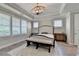 Primary bedroom with tray ceilings, shutters, bench, and elegant lighting at 3460 Montebello Pkwy, Cumming, GA 30028